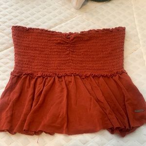 Strapless rust red crop top! (There is a small tear on the back)